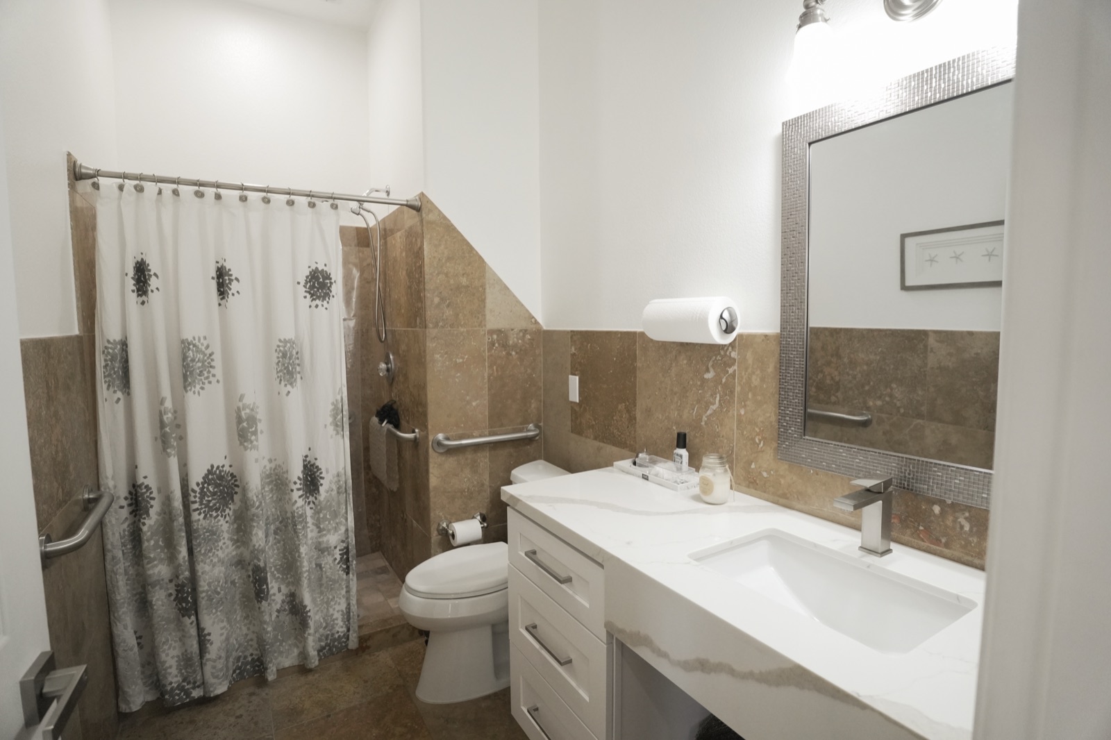 An accessible walk-in shower with a bench and grab bars