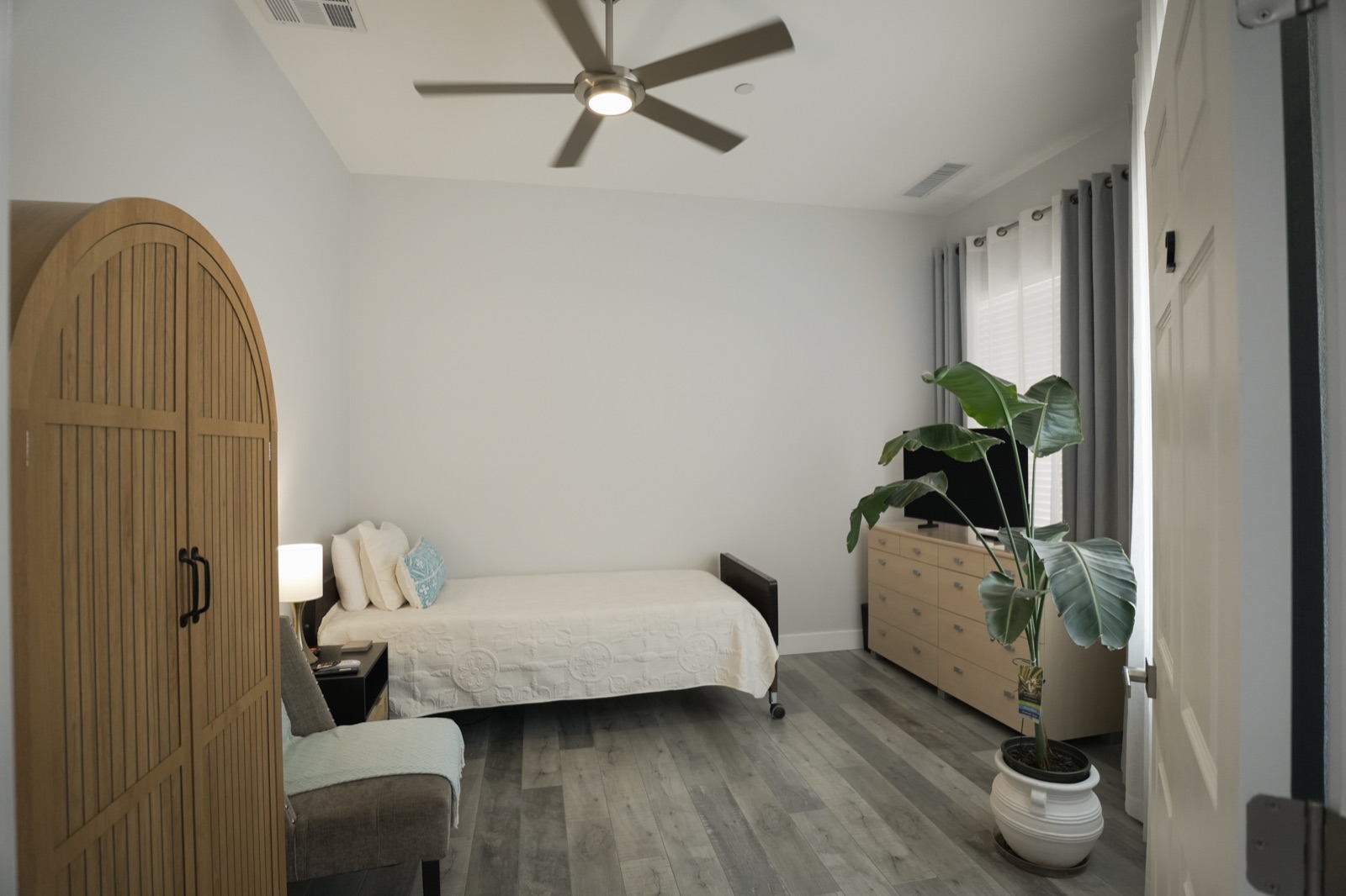 A spacious bedroom with a wide doorway