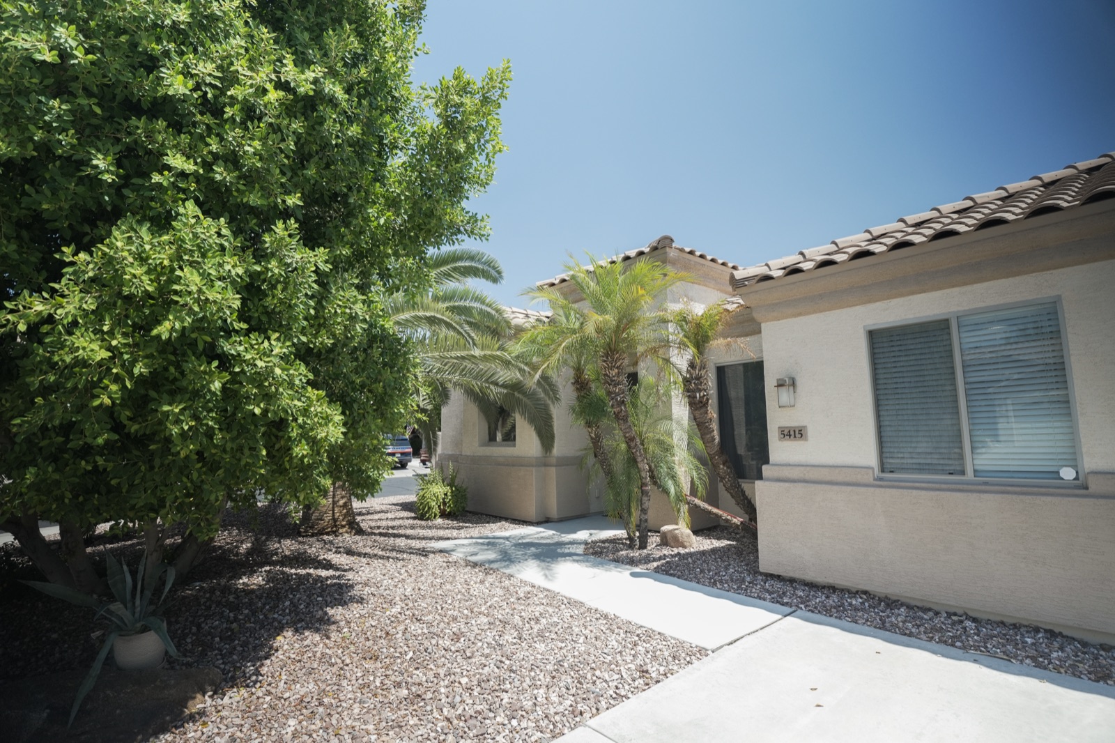 The front of the Brightest Light home with mature desert landscaping