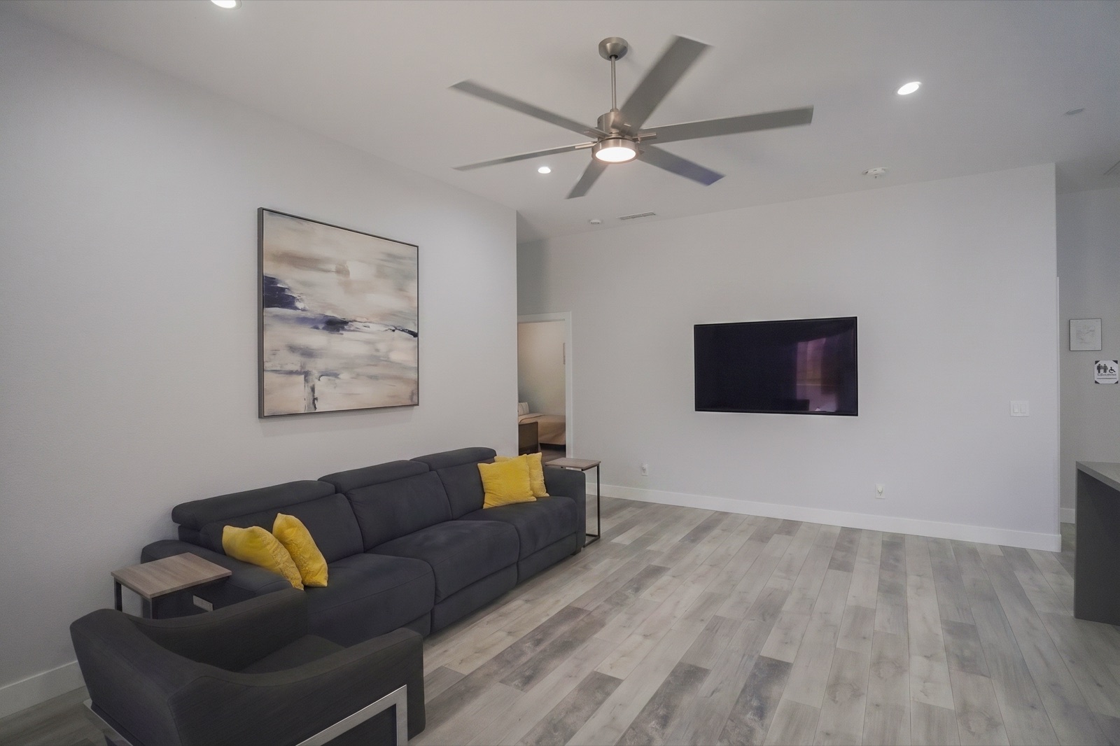 A warm, sunlit common living room with comfortable seating